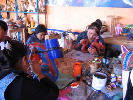 Family painting alebrijes at family workshop in San Martin Tilcajete.